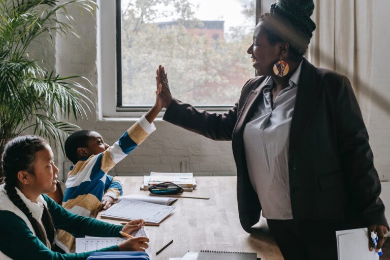 cheerful black teacher with diverse schoolkids